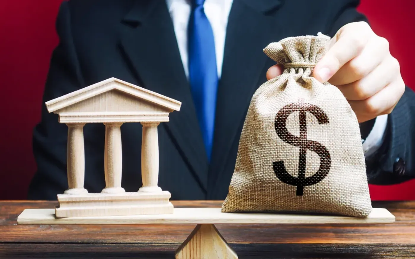 Illustration of a man holding a sack with a dollar sign on it