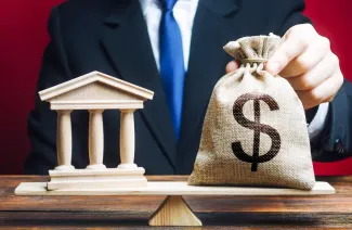 Illustration of a man holding a sack with a dollar sign on it