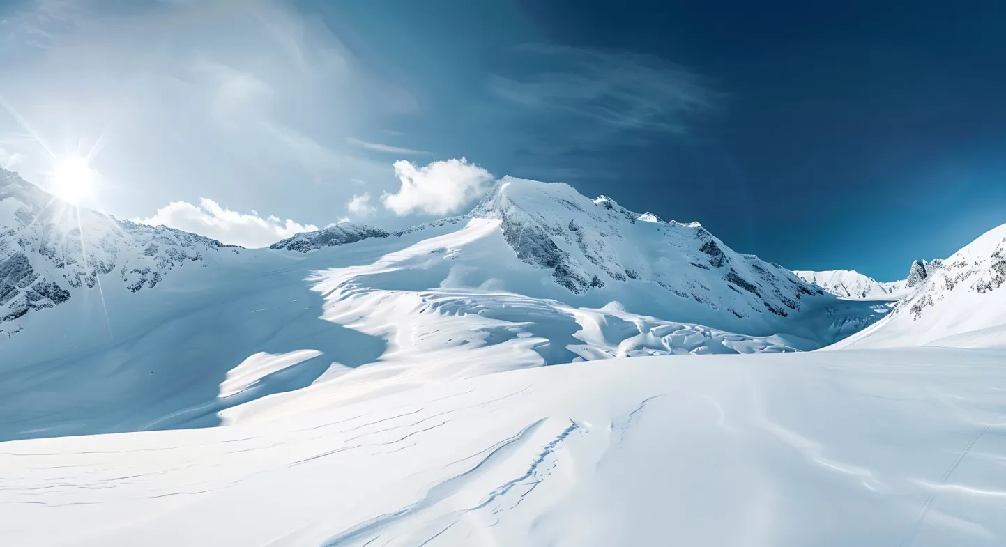 Snowy mountain peaks under a bright blue sky